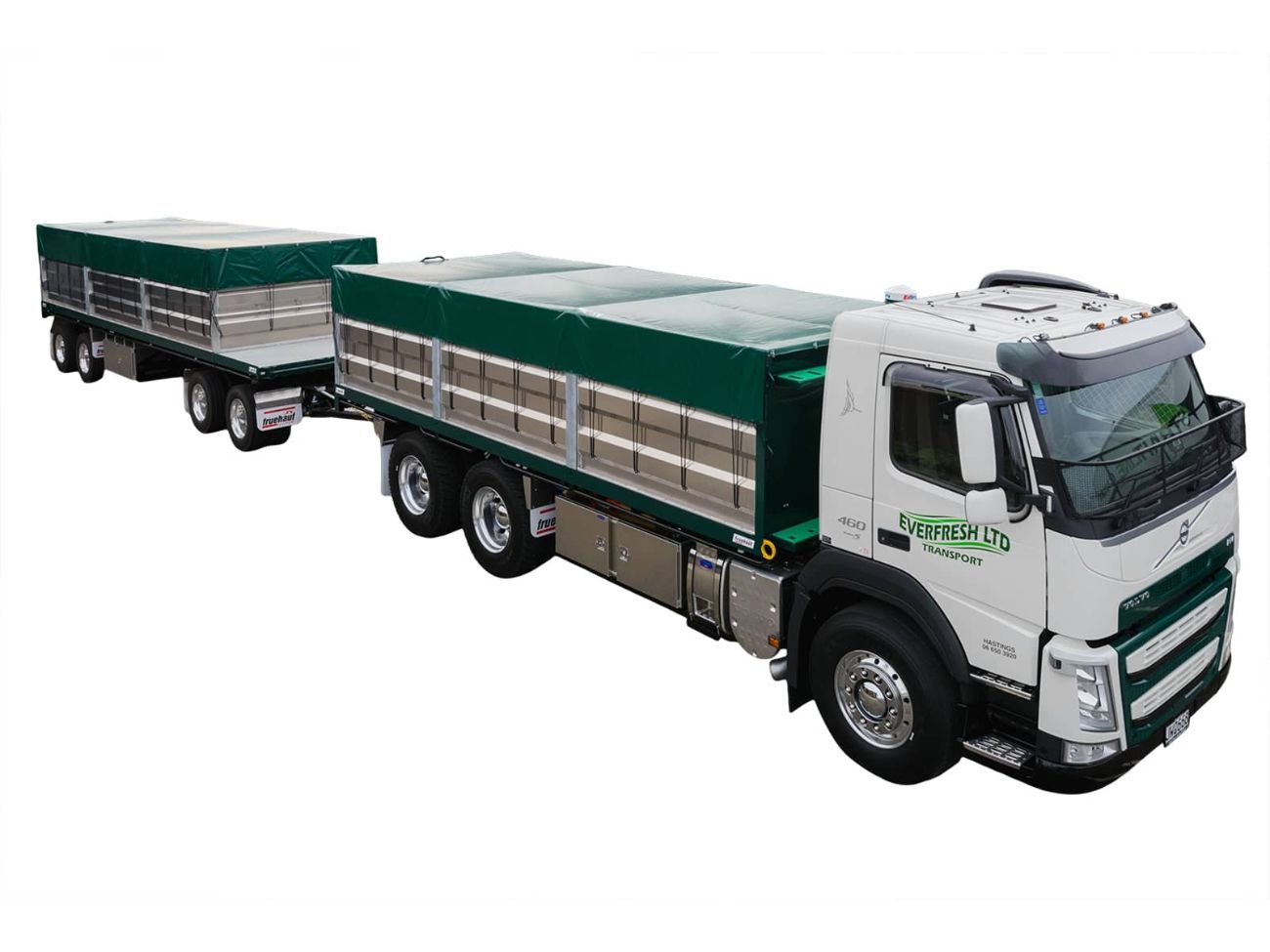 Truck and trailer with green roll over cover.